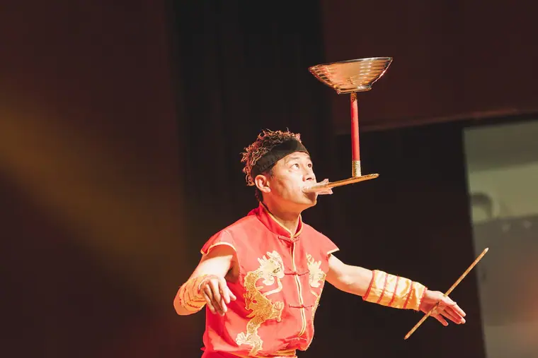 臺南市新化演藝廳《魔幻嘉年華》 演出劇照:紅色中國風服裝雜耍演員以口叼桿轉碗