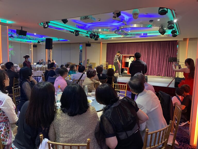 嘉義企業尾牙宴會廳,賓客圍桌觀看魔術表演