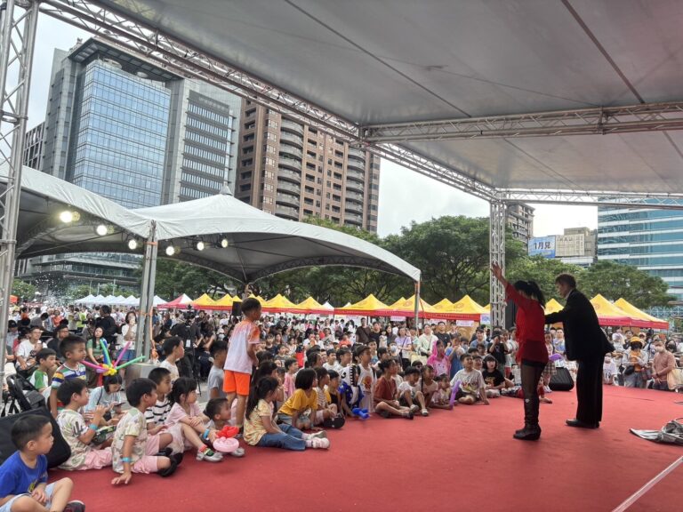 桃園藝文廣場「有愛無礙親子 FUN 派對」，魔術師在舞台上表演，台前小朋友席地而坐
